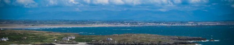 picture of Rhoscolyn Beacon & Mountain backdrop over sea